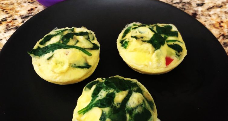 three poached egg bites with spinach, red bell pepper, and feta cheese
